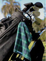 Emerald and blue plaid golf towel by Par Bleu Golf hanging from a golf bag.