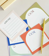 Aim Studio Co. Goal Setting Cards arranged in a wooden stand with goal-planning prompts visible.