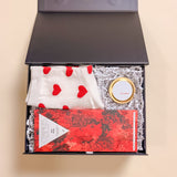 Mini Valentine’s Day gift box Be Mine featuring heart socks, small soy candle, and gourmet red wine chocolate bar.”