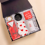 Valentine’s Day gift box for her with ring tray, seaberry rose clay bath bomb, heart socks, Be Mine candle, red wine chocolate, and coffee mug.