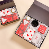 Luxury Valentine’s Day gift box Be Mine featuring heart socks, soy candle, red wine chocolate bar, black ring tray, bath bomb, and coffee cup.