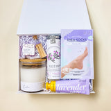 Lavender Calm Spa Gift Box featuring lavender shea bath bombs, calm soy candle, flying bird bontanicals peace of mind tea, avry beauty lavender shea-socks, lavender sage shea butter lotion