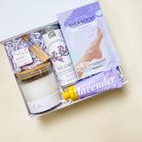 Lavender Calm Spa Gift Box featuring lavender shea bath bombs, calm soy candle, flying bird bontanicals peace of mind tea, avry beauty lavender shea-socks, lavender sage shea butter lotion