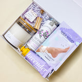 Lavender Calm Spa Gift Box featuring lavender shea bath bombs, calm soy candle, flying bird bontanicals peace of mind tea, avry beauty lavender shea-socks, lavender sage shea butter lotion