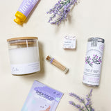 Lavender Calm Spa Gift Box featuring lavender shea bath bombs, calm soy candle, flying bird bontanicals peace of mind tea, avry beauty lavender shea-socks, lavender sage shea butter lotion