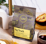 Front of Olympia Coffee Company Big Truck Coffee Blend bag featuring illustrated gray and yellow packaging, medium-dark roast