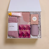 Wine Down gift box with wine tumbler, raspberry chocolate, champagne hour body lotion, rose candy gummies, and orchid cozy socks.