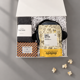 A Night In movie gift box with popcorn popper, buttery popcorn, movie trivia, cozy socks, candle and chocolates.