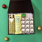 Mini Holiday Gather hostess gift with salami, hot honey, chocolate chip cookies, sugared cranberries and a falala cloth.