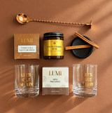 Holiday gift box for clients and employees with hot buttered rum mix, festive glassware, caramels and pretzels