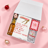 Holiday Hostess gift box products styled in a colorful Christmas flat lay