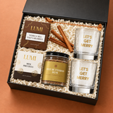 Angled view of the Holiday Spirit gift box with Let’s Get Merry glasses and warm-spiced cocktail mix