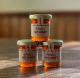 Mini 1.5 oz jar of Mike's Hot Honey featuring sweet honey infused with chili peppers for a spicy flavor boost.