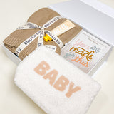Angled view of Confete Mommy + Me gift box showing plush baby pouch and cozy knit blanket.