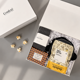 Movie night gift box filled with gourmet popcorn, cozy socks, a candle, trivia game and sweet treats.