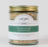 Premium Salt Sisters Steakhouse Seasoning blend in a jar, ideal for enhancing steaks, burgers, and roasted vegetables.