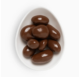 Close-up of Sugarfina Bourbon Pecans showing glossy caramelized coating and rich, buttery bourbon flavor.