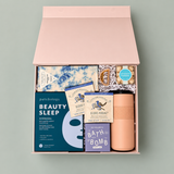 The Reset wellness gift box with tea, chocolate, skincare, bath bomb, beige tumbler.