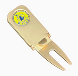 Beaver Tail Golf Club Alfred cigar holder and divot tool resting on a golf green beside a golf ball.