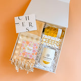 New homeowner gift box with cozy home essentials and celebratory housewarming gifts