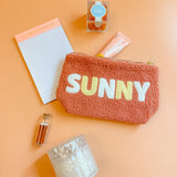 Girly summer self-care gift box with peach tones, teddy pouch, candle, candy, and lotion