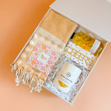 Modern housewarming gift box with neutral home decor and kitchen accessories
