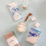 Apres Gift Box, self care, cozy socks, marshmello crisp chocolate, candle, sugarfina champagne bubbles, bath bomb, confete party