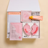 BFF friendship gift box with best friends heart flask, happy hour notepad, Patchology calm sheet mask, rose eye gels, and champagne hour shea butter lotion.