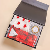 Be Mine Mini Valentine’s Day gift box with heart socks, 2oz Be Mine soy candle, and red wine Compartés chocolate bar.