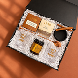 Angled view of the Holiday Spirit gift box with Let’s Get Merry glasses and warm-spiced cocktail mix
