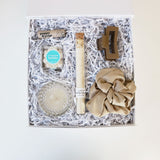 Indulge in the tranquility of our Island Time Gift Box – a curated escape with coconut lip balm, prosecco candle, silk scrunchie, caramel claw clip, oatmeal bath salt, and champagne candy. 