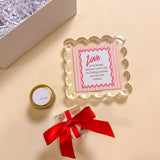Romantic Valentine’s or anniversary gift box featuring LOVE quote picture frame, small soy candle, and red bow bon bons.