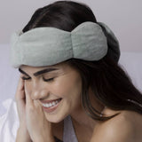 Sage Nodpod Weighted Sleep Mask styled as a cozy self-care gift