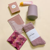 Wine Down self care gift box with wine tumbler, cozy socks, champagne hour lotion, raspberry chocolate candy, and rose gummies.