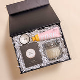 Mini luxury XOXO Valentine’s Day gift box featuring XO ring dish, merlot wine gummy candy, rose shea butter body lotion, and suede soy candle.