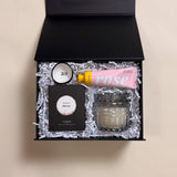 XOXO Valentine’s Day gift box with XO ring tray, merlot wine gummies, rose shea butter lotion, and heathered suede soy candle.”