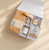 Comfort care package for a friend filled with cozy baking supplies, a calming candle and sweet treats.