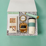 Employee birthday gift box with a reusable tumbler, chocolate, caramel popcorn, candle, notepad and party horn.