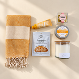 Encouragement gift box with sourdough starter, gourmet bread dip, candle, hand cream and chocolates.