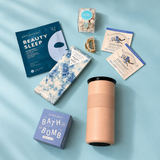 Employee wellness care package with herbal tea, reusable ceramic tumbler, and self-care treats.
