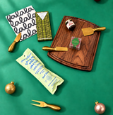 Holiday Gather charcuterie gift box with walnut board, gold cheese tools, salami, hot honey, cookies and cranberries.

