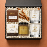Holiday Spirit cocktail gift box with two festive rocks glasses, hot buttered rum mix, caramels and pretzels
