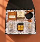 Holiday Spirit cocktail gift box with two festive rocks glasses, hot buttered rum mix, caramels and pretzels
