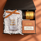 Mini Holiday Spirit gift box with a festive rocks glass, hot buttered rum mix, caramels and cinnamon sticks