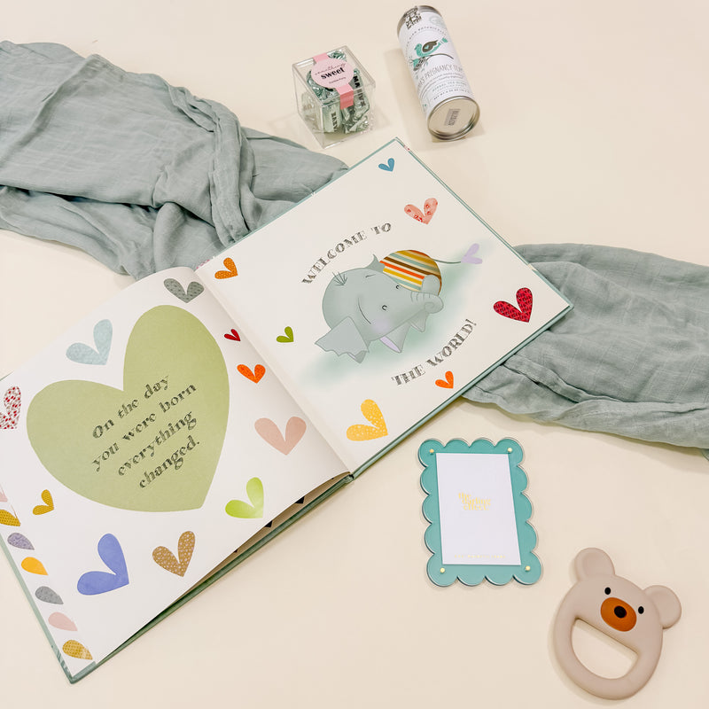 Close-up of Confete New Baby Gift Box showing Maeve Bon Bons and Botanical Birds pregnancy tea for the new mom.