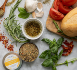Salt Sisters herb bread dip seasoning in a 1.5 oz tin, ideal for mixing with olive oil and serving with artisan bread.