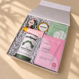 Spa gift box for her featuring Patchology skincare, Nodpod weighted eye mask, rose hand cream and sweet treats.
