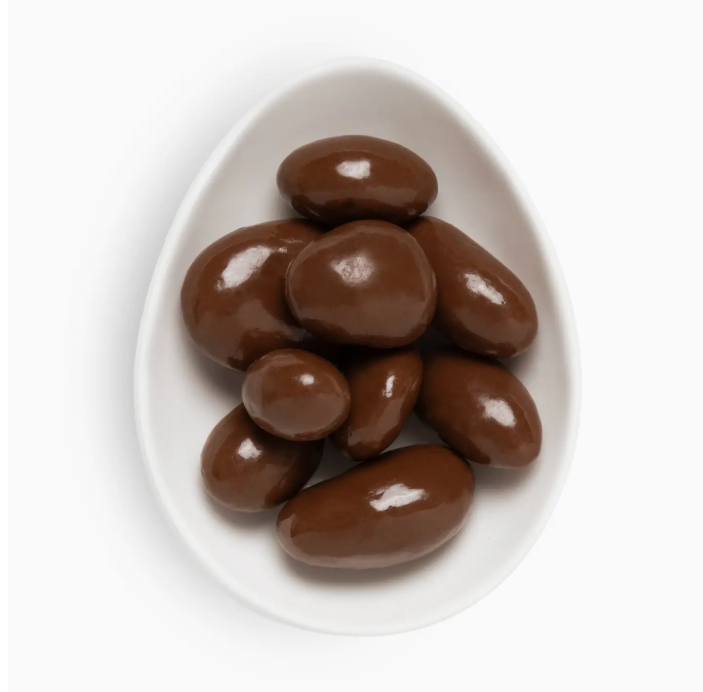 Close-up of Sugarfina Bourbon Pecans showing glossy caramelized coating and rich, buttery bourbon flavor.